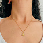Load image into Gallery viewer, Gold necklace with a small pendant worn by a person
