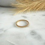 Load image into Gallery viewer, Gold ring on a marble surface with dried grass
