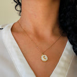 Load image into Gallery viewer, A model wearing a gold plated stainless steel necklace with a enamel white moon pendant
