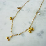 Load image into Gallery viewer, Gold charm necklace made of stainless steel with a zirconia, heart, cherries, bow and pearl charms
