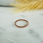 Load image into Gallery viewer, Beaded ring on a marble surface with dried grass in the background
