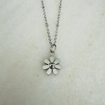 Load image into Gallery viewer, Silver flower pendant necklace on a light background

