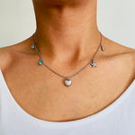 Load image into Gallery viewer, Stainless Steel charm necklace with a shell, turquoise, heart, starfish and conch charms worn by a woman
