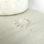 Load image into Gallery viewer, Silver ring with wavy design on a light gray surface
