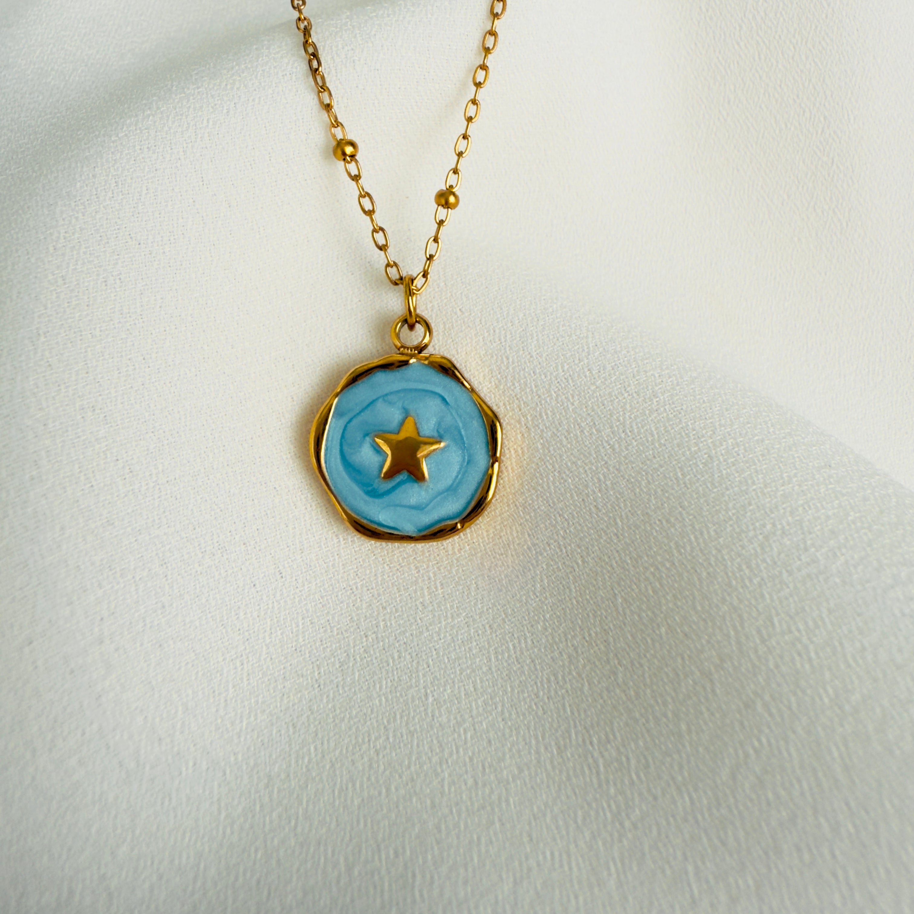 Gold plated stainless steel necklace with a round blue enamel star pendant