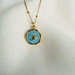 Load image into Gallery viewer, Gold plated stainless steel necklace with a round blue enamel star pendant
