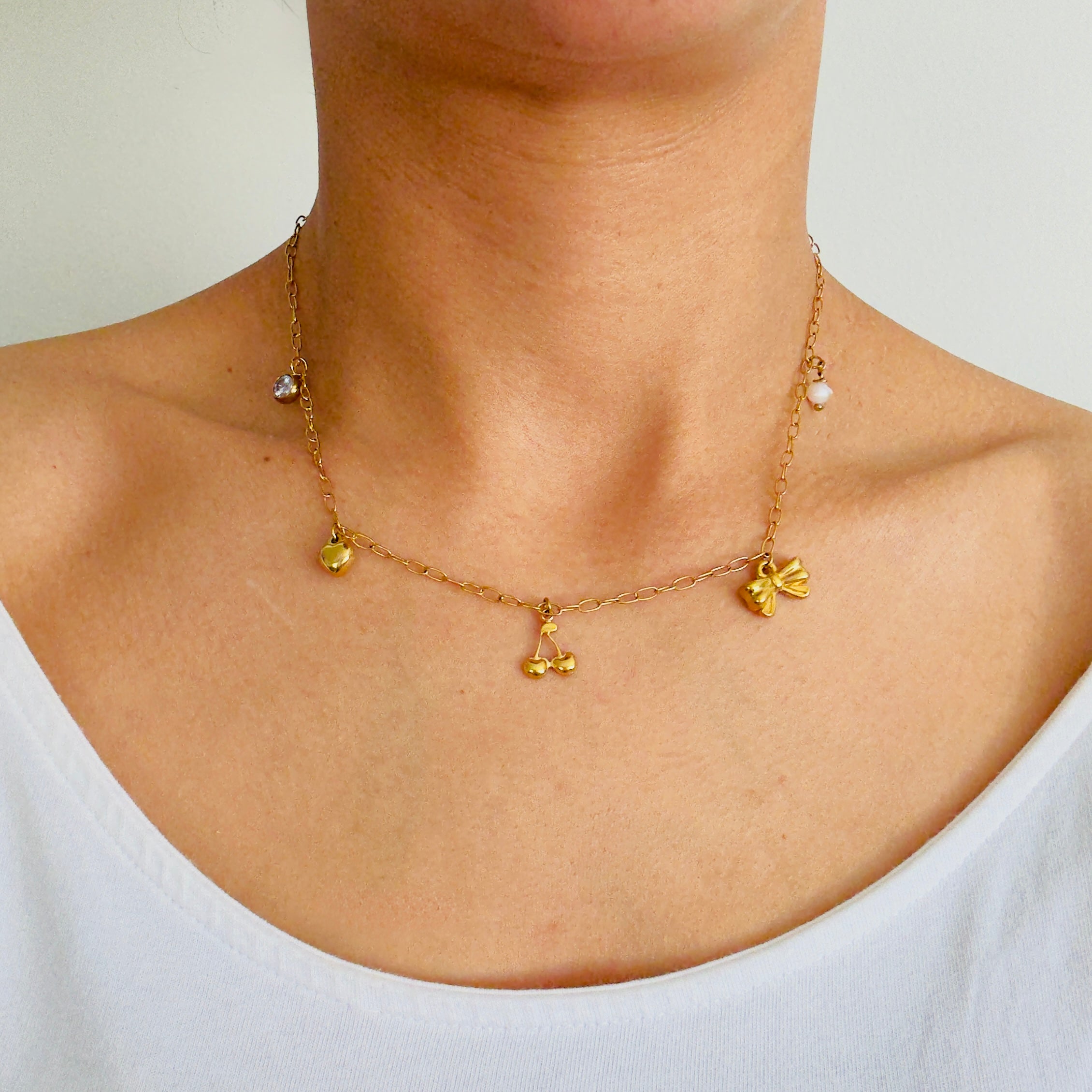 Personalised charm necklace in gold worn by a women