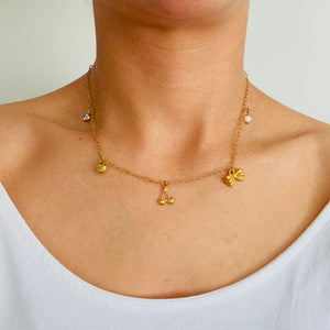 Personalised charm necklace in gold worn by a women
